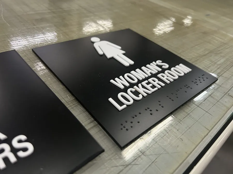 ADA-compliant Braille locker room sign fabricated in Dallas