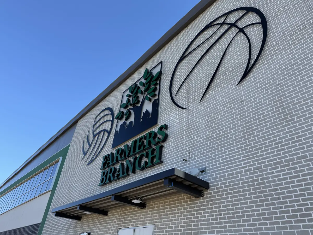 Dimensional Farmers Branch letters and basketball logo mounted on brick facade in Dallas
