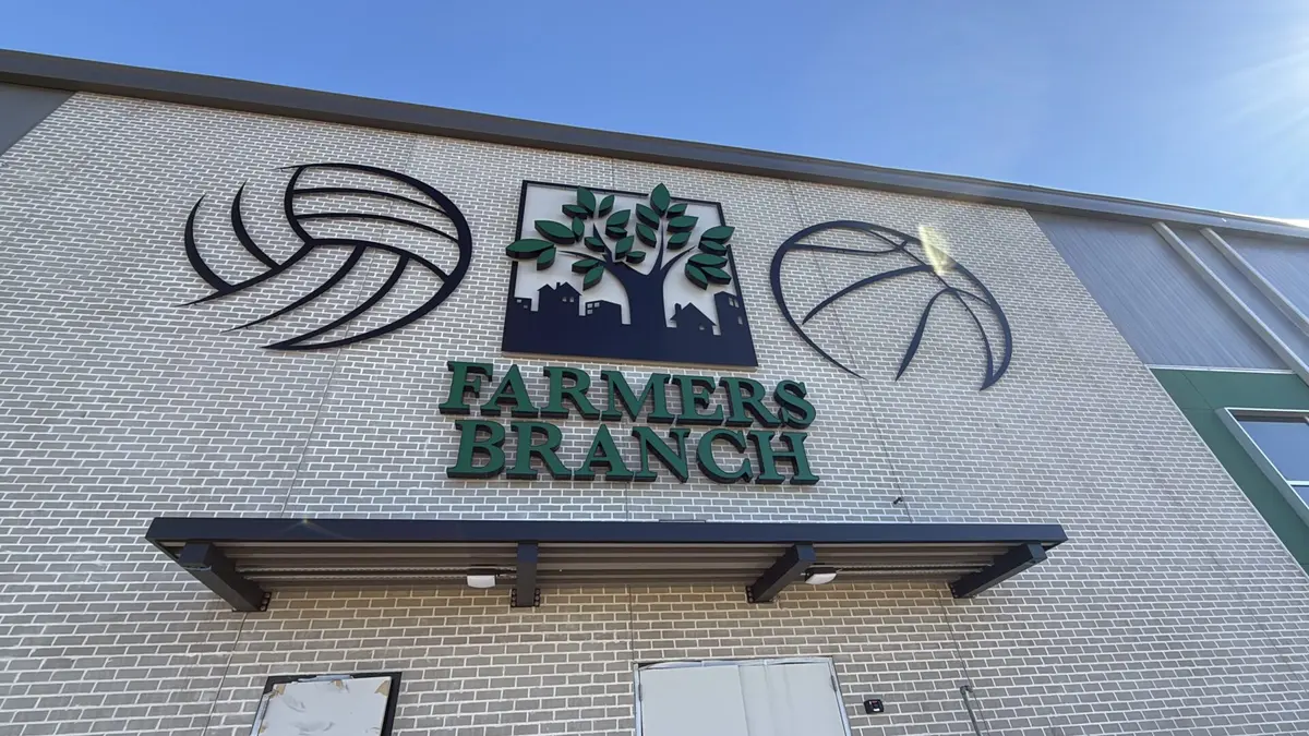 Dimensional volleyball tree and basketball logo signs on Farmers Branch facility in Dallas