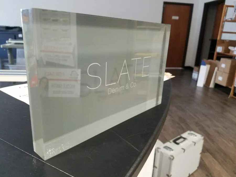 Etched clear acrylic block sign for Slate Denim and Co made in Dallas