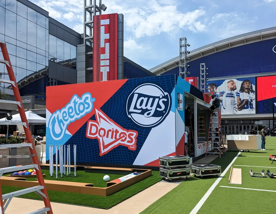 Large format event graphics wall for Cheetos, Doritos and Lays at a Dallas stadium