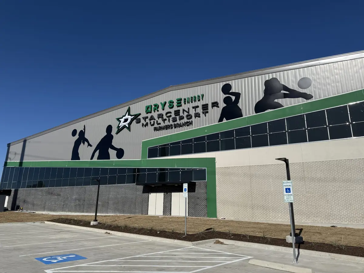 Exterior building signage with channel letters and sports silhouette graphics at StarCenter Dallas