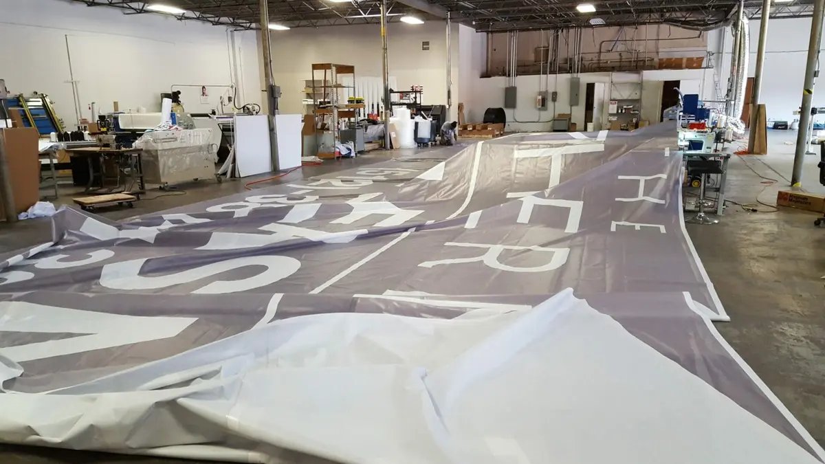 Grand format banner sewing and finishing station in Dallas print facility