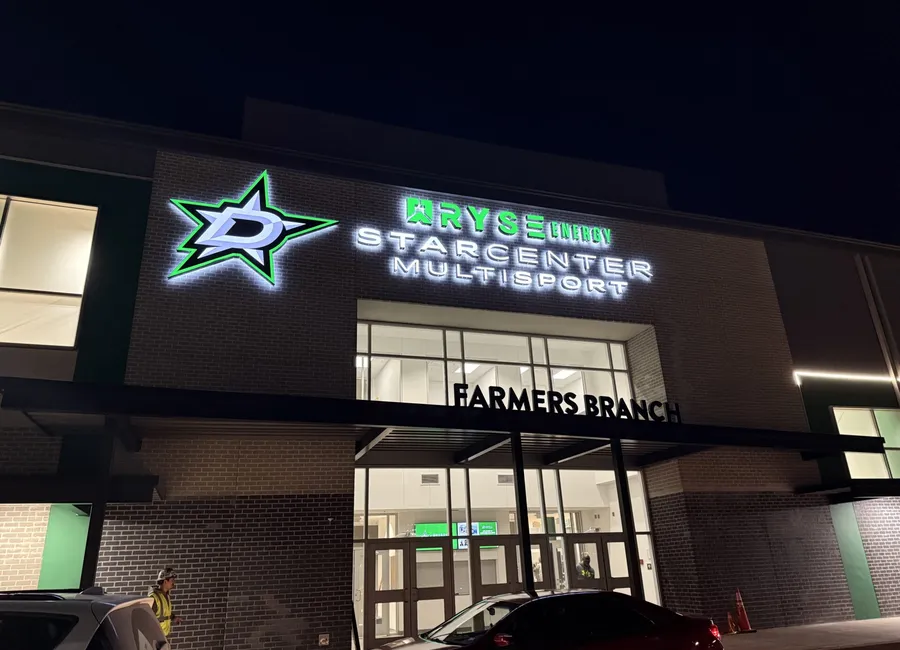 Halo-lit channel letters and illuminated Dallas Stars logo at night