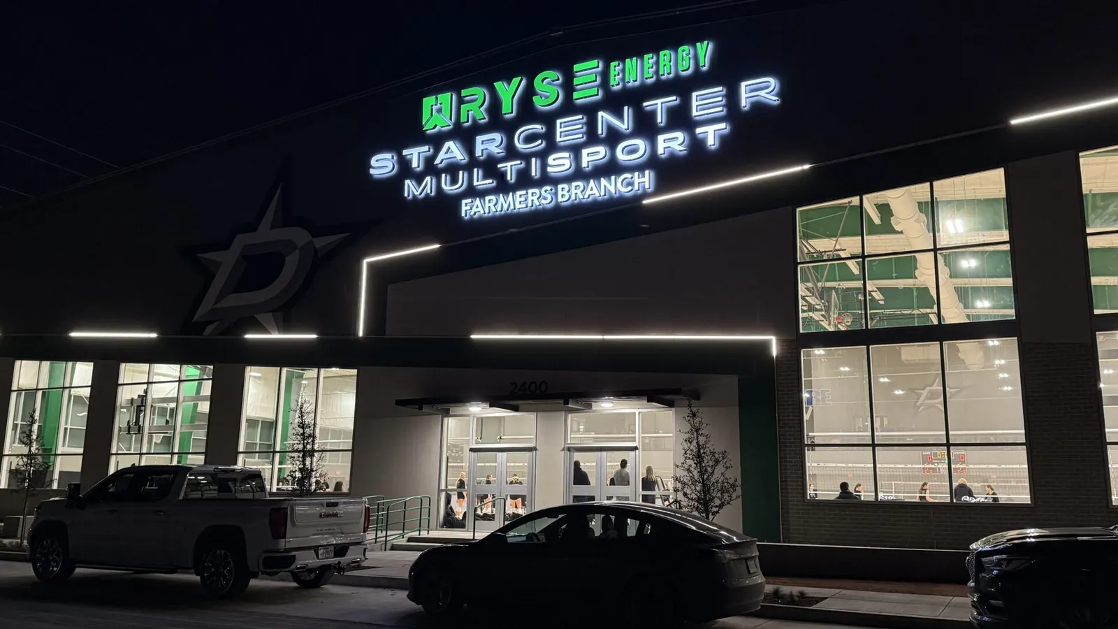 Illuminated channel letter storefront sign glowing at night in Dallas, built by Positive Marketing USA