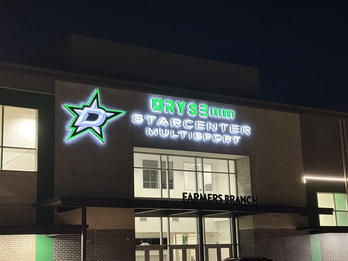 LED illuminated channel letter sign glowing at night at StarCenter Multisport Dallas