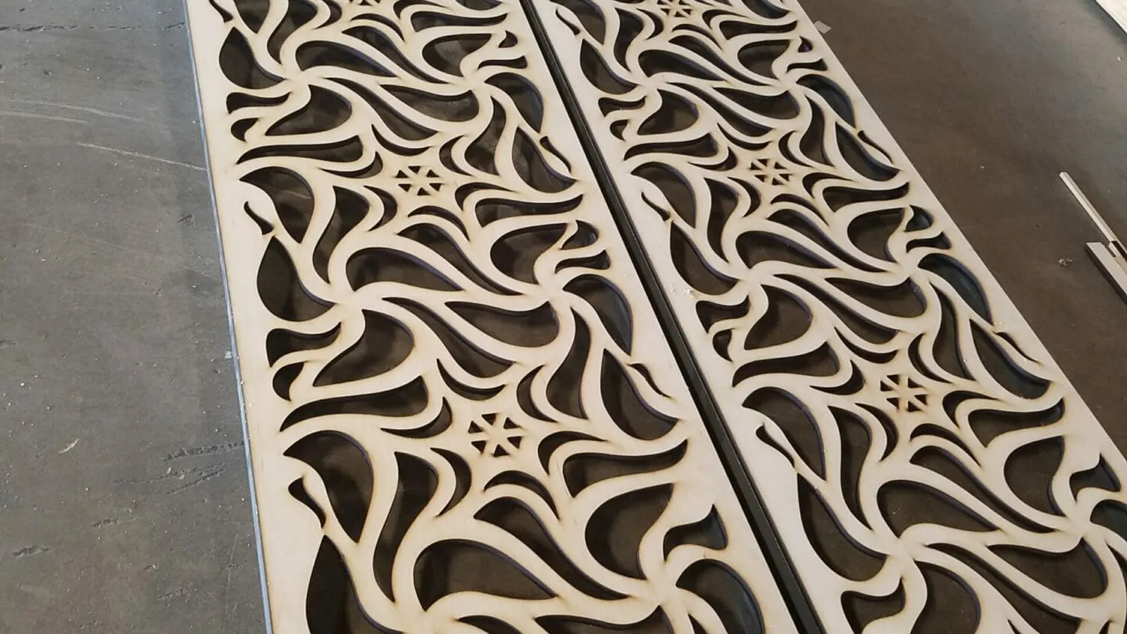 Large laser-cut decorative plywood panel fabricated by Positive Marketing USA in Dallas