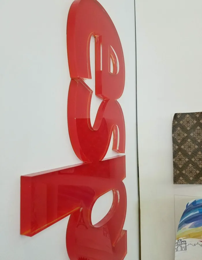 Laser-cut red acrylic dimensional letters with polished edges in Dallas