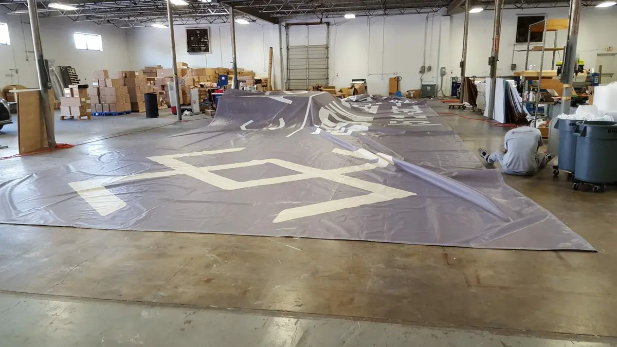 Oversized vinyl banner during large format production quality check in Dallas